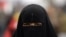 Egypt -- An anti-government protestor wears a full veil, or niqab, on Tahrir Square in Cairo, 07Feb2011